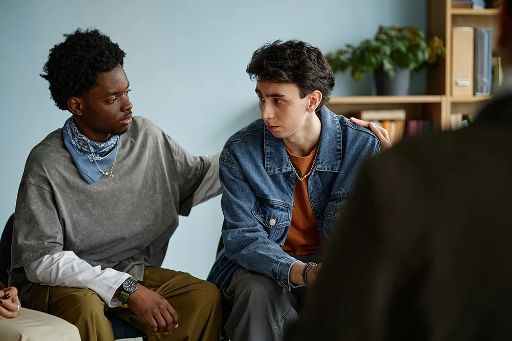 Teen boy receiving guidance from a therapist on coping with life changes and transitions