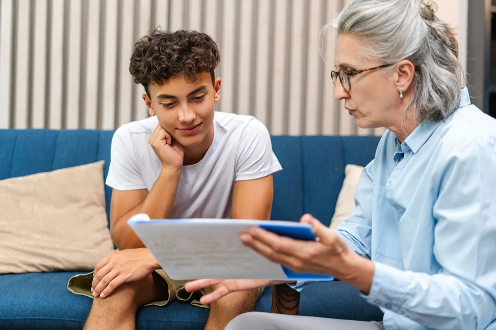 a teen sitting in therapy with counselor