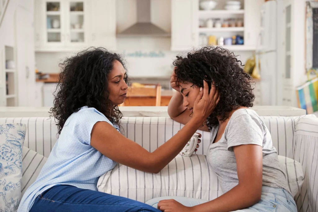a-teen-girl-being-comforted-by-her-mom