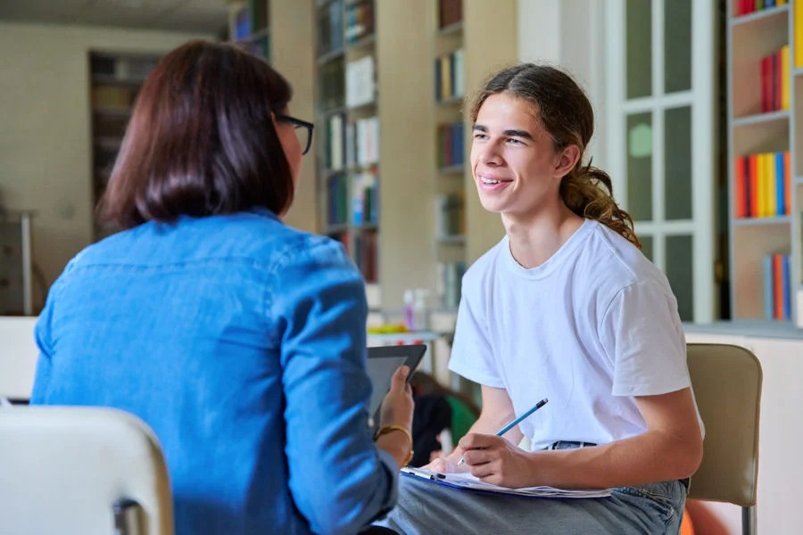 teen boy meeting with mental health counselor