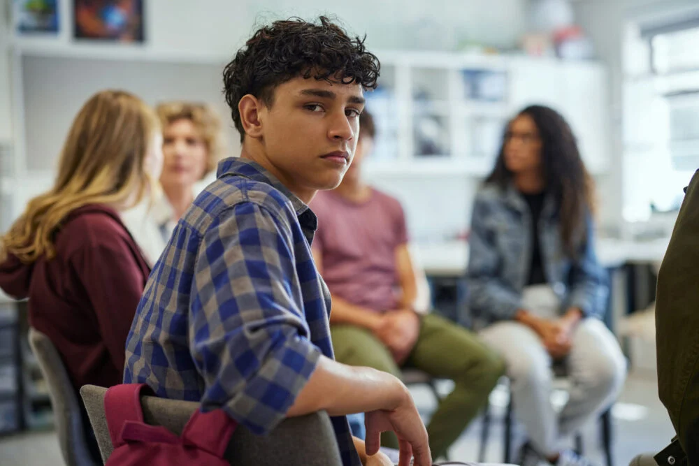 teen boy in group therapy session learning benefits of therapy