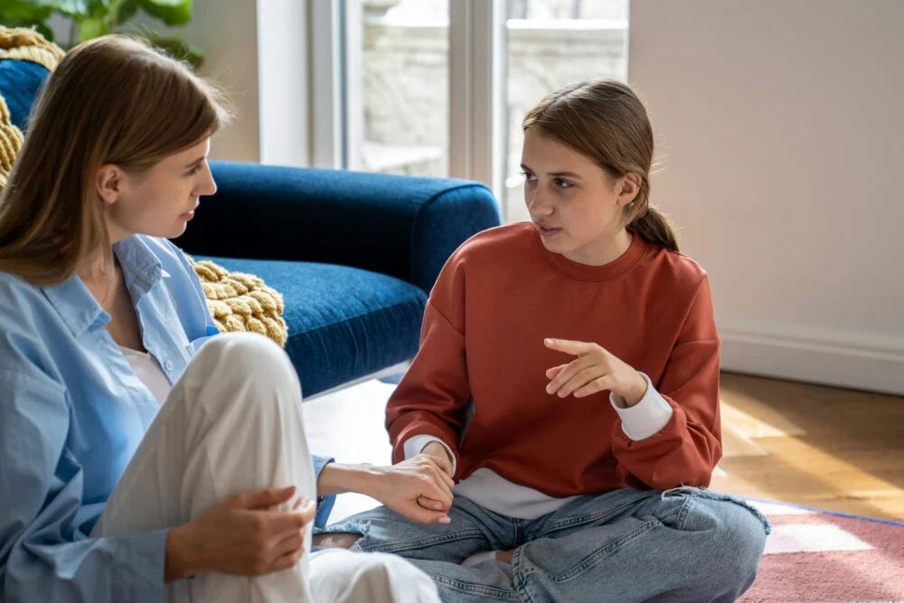 mom comforting her daughter while managing family stress