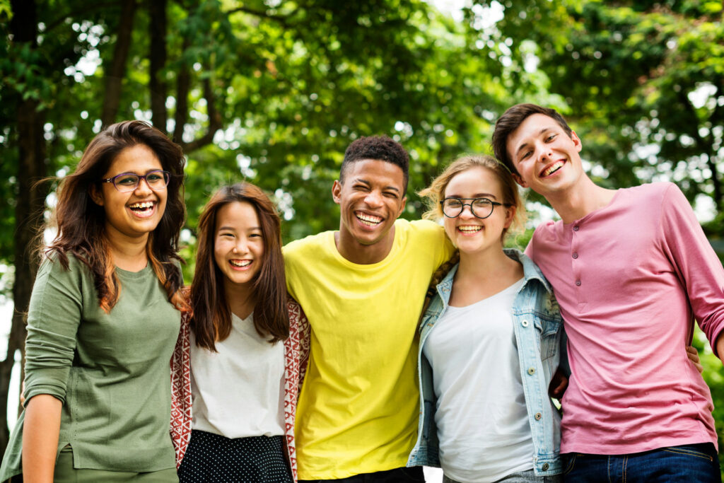 a-group-of-teens-smiling-in-nature