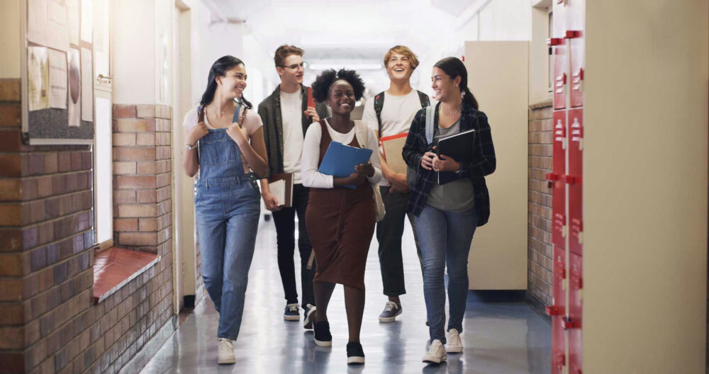 teens walking down an aisle discussing a back-to-school checklist